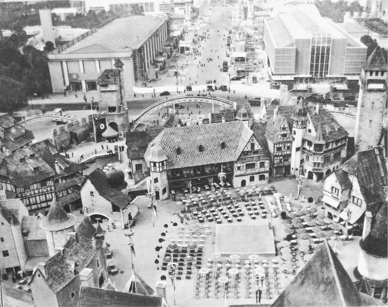 A photograph of an eagle-eye view of a city with medieval-themed buildings.