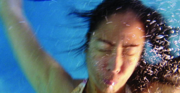 Underwater photo of a submerged person, face on.