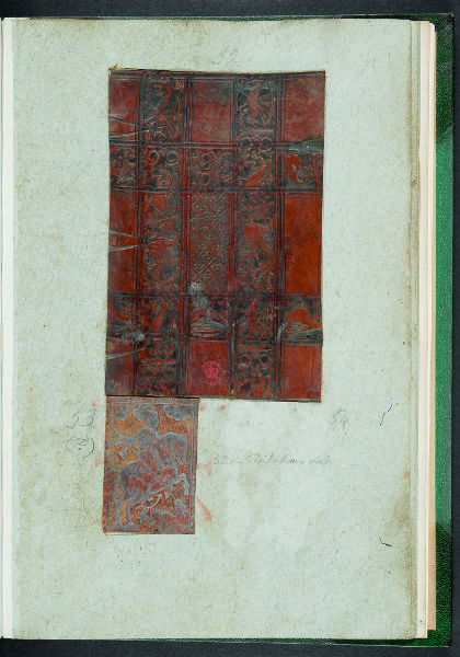 A rectangular cutout of stamped leather pasted to a blank page.