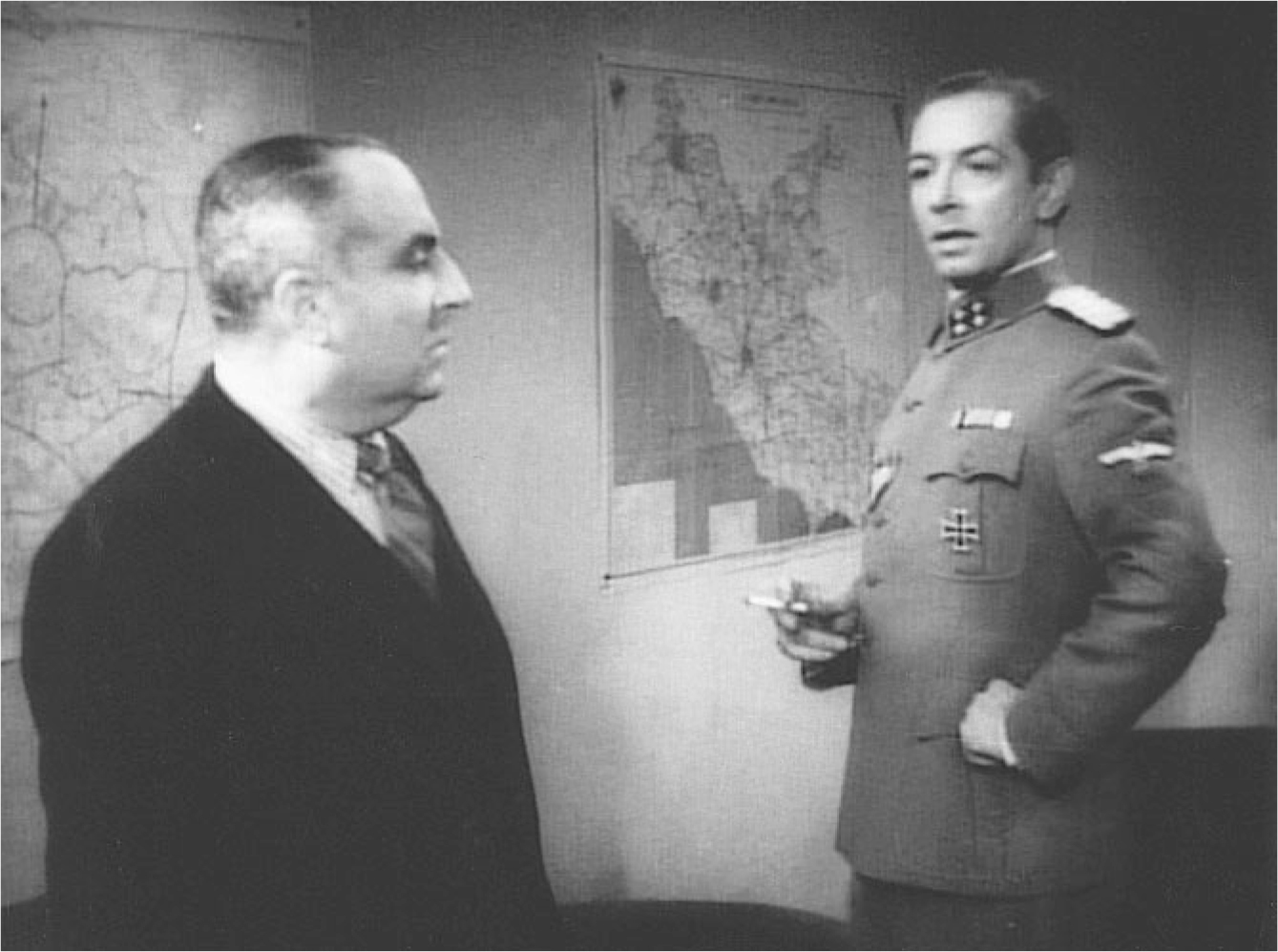The exhibit depicts a scene from “Roma, città aperta” where a man in formal attire is engaged in a conversation with another man dressed in a uniform.