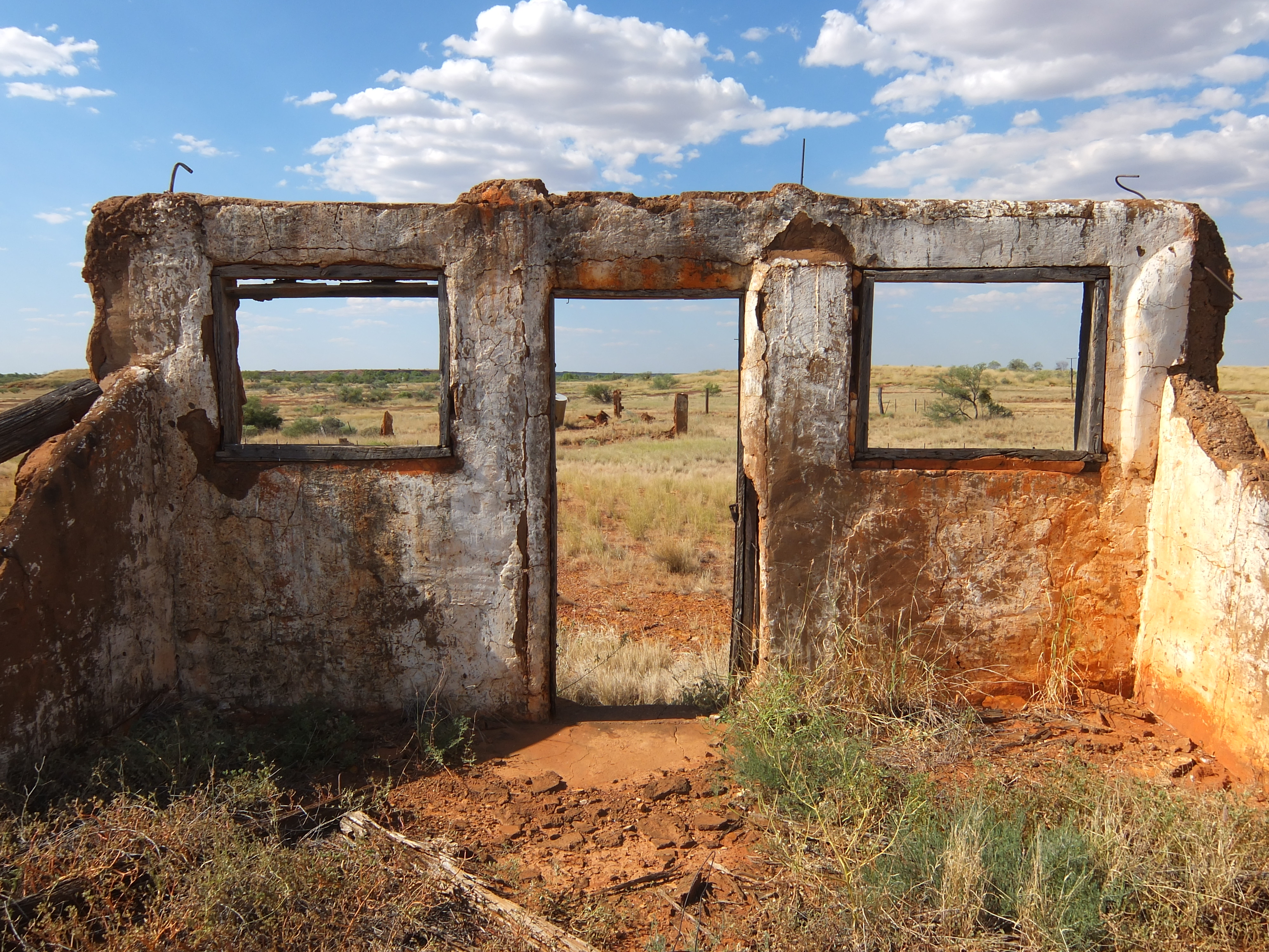 View from inside the Old Balgo Mission dormitory entrance, including the empty spaces of a door and two windows.