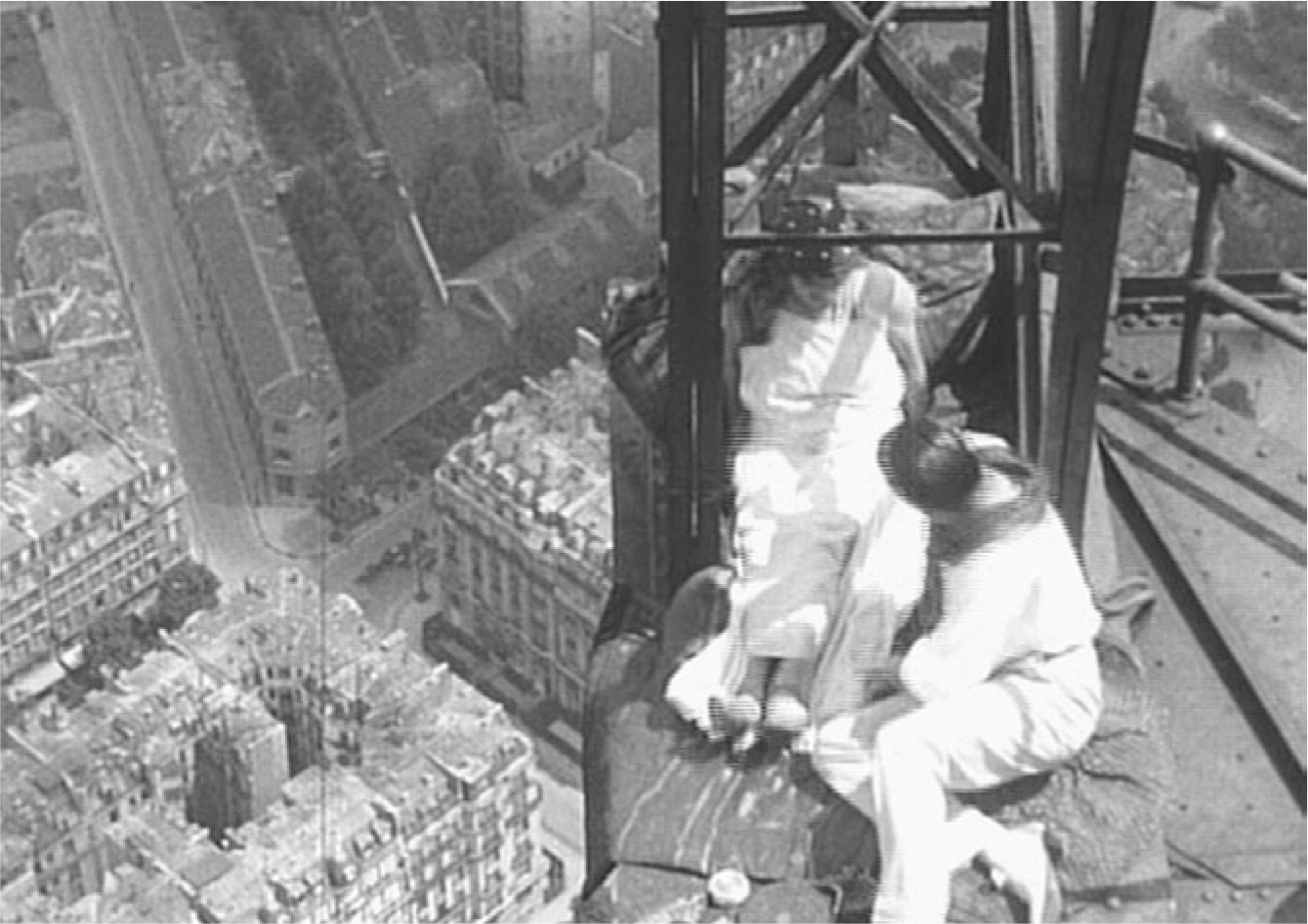 The exhibit depicts a scene from “Paris qui dort,” featuring two characters sitting near the tip of the Eiffel Tower.