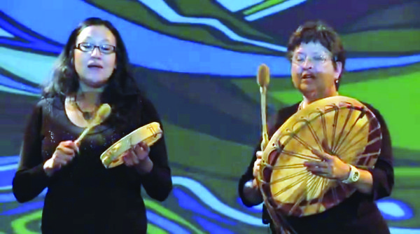 Two women with hand drums.