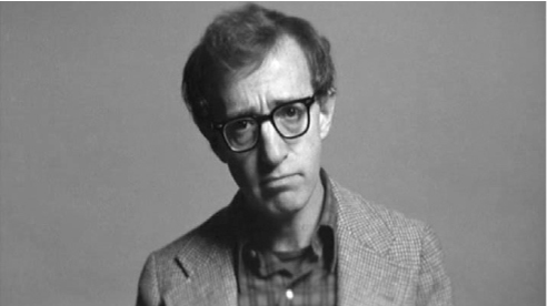 The exhibit displays a formal portrait of Woody Allen wearing glasses.