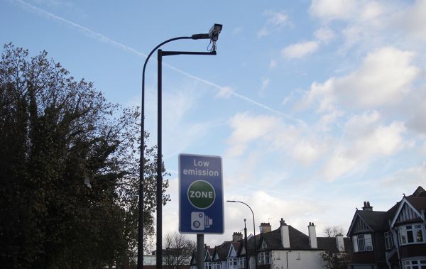 Low-emission zone boundary sign and traffic camera on the Old Kent Road in Southeast London.
