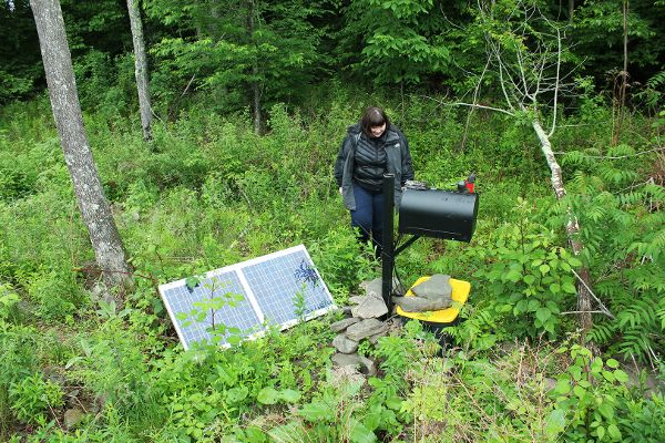 Citizen Sense Researcher, Helen Pritchard, inspecting Frackbox and solar panel nearby compressor station.