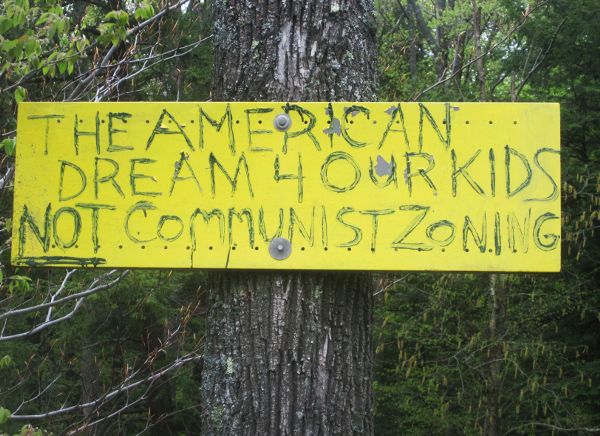 Sign protesting fracking regulations for zoning, which would maintain a minimum setback between industry and other land uses.