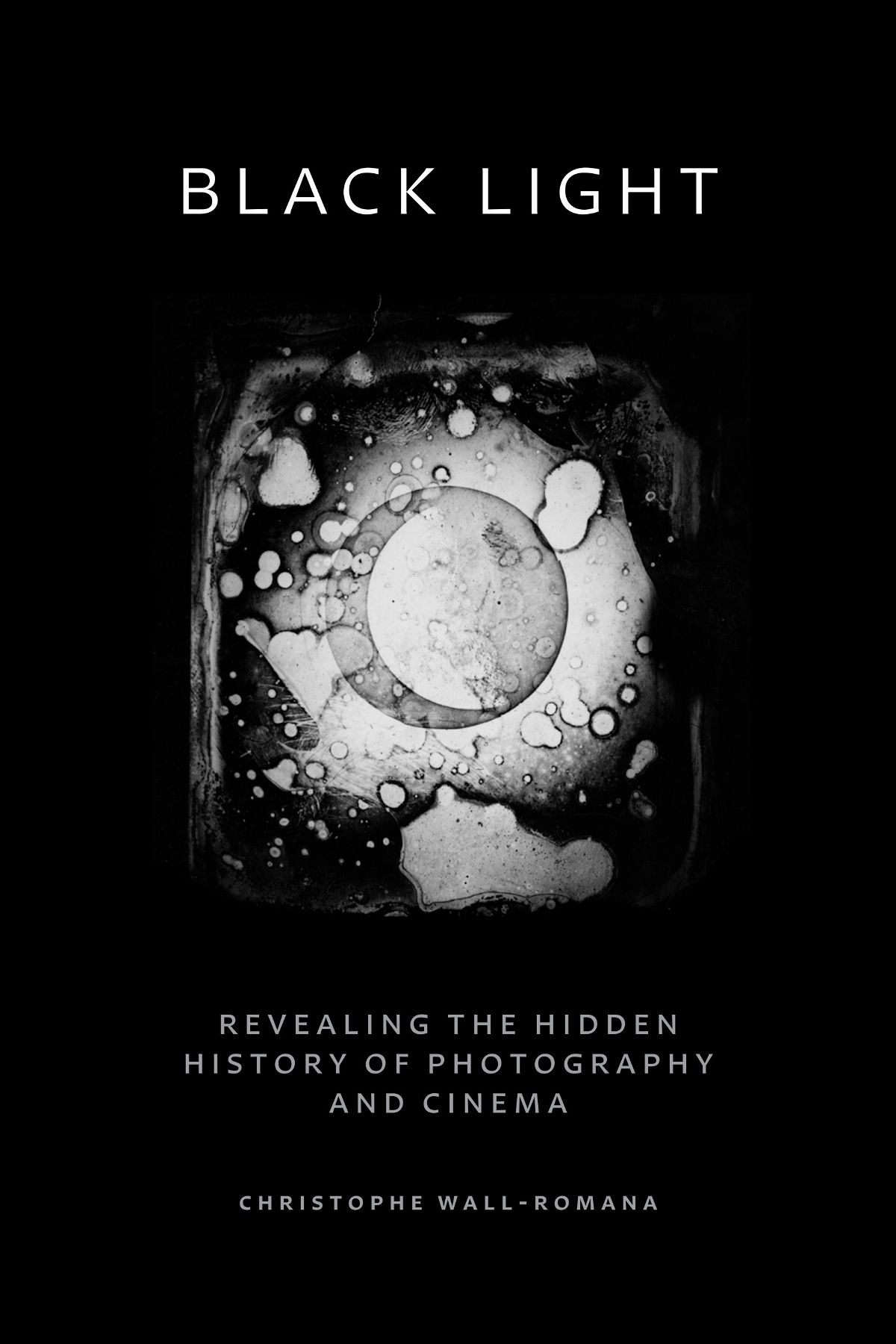 Black background with burnt film cell at center Title in white above, subtitle and author in gray at bottom.