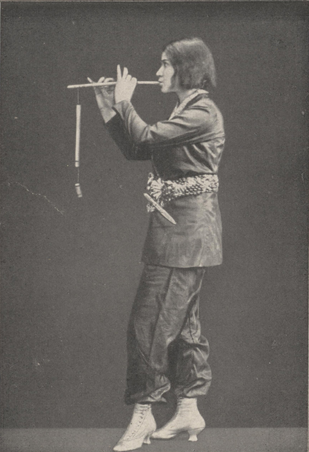The exhibit features a side view illustration of a person playing a wind instrument, producing sound by blowing into it.