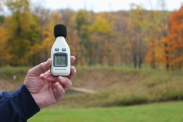 Participant showing digital decibel meter for documenting noise from fracking industry.