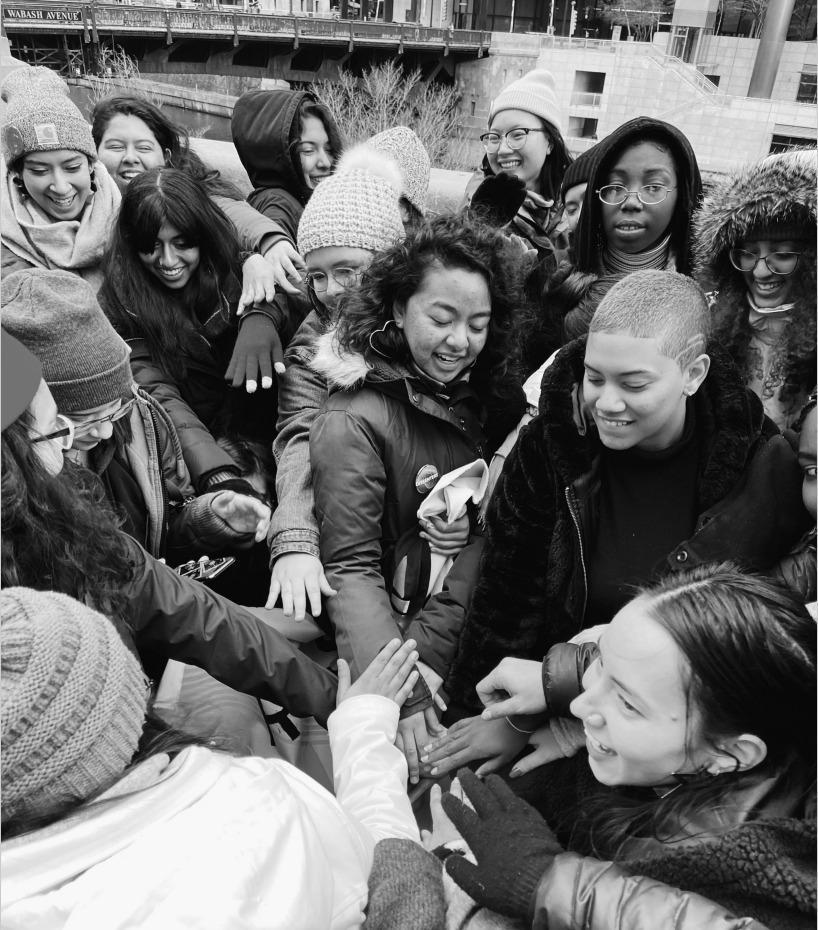 A black-and-white photo of Dissenters leaders in a circle putting their hands together in the middle of the circle.