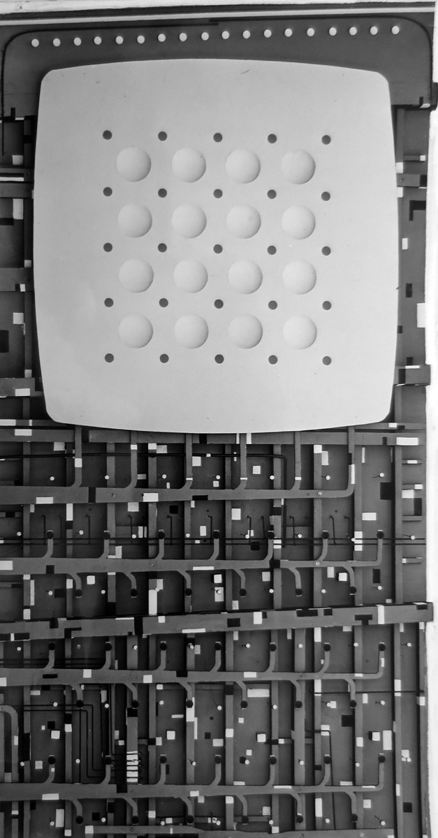 Model of ceiling with exposed air ducts. Nearly half the ceiling is covered with a white surface with a grid of lights and shallow domes.