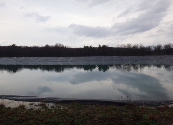 Impoundment pond for holding fracking flowback fluid.