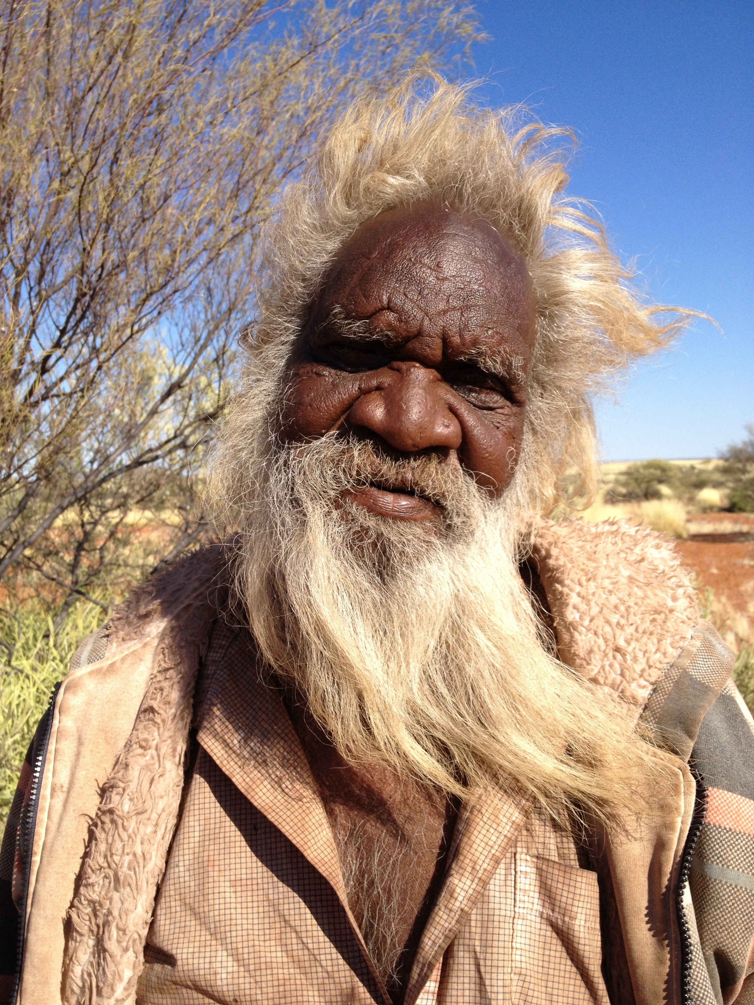 Close-up view of Larry as the sun lights up his face. His beard and hair blow to the right in the wind.