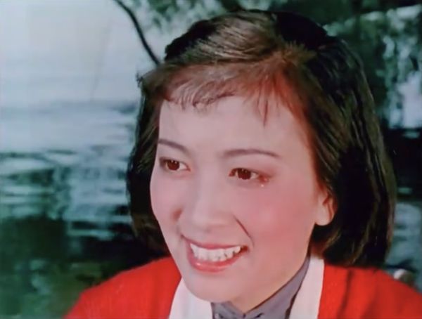 Closeup of the woman on the boat showing tears at the corners of her eyes.