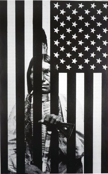 Photocollage creating the illusion that a Native American man is seated behind the bars of the United States flag, oriented vertically.