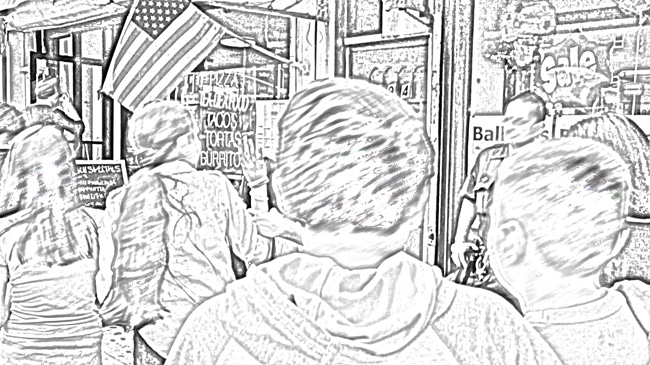 Five students walk past shops displaying SALE signs, American flags, and menus. A police officer leans against a building, hand on holster.