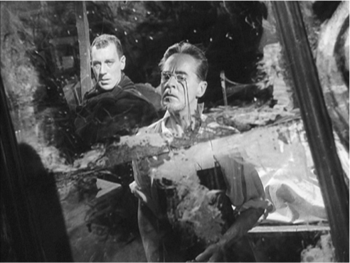 The exhibit features a still from the movie “The Magician,” displaying the reflections of two male characters.