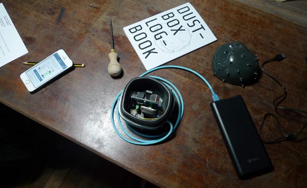 Setting up a Dustbox monitor and Logbook with instructions at participant location in New Cross Gate, London.