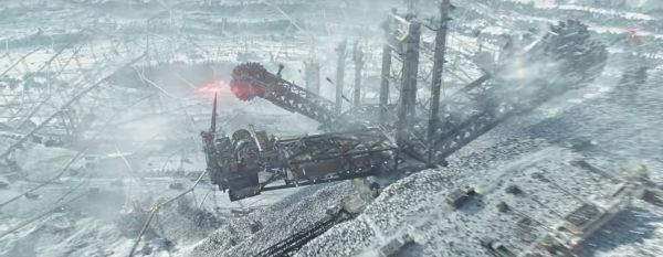Aerial shot of a large crane at work in a snowy landscape.