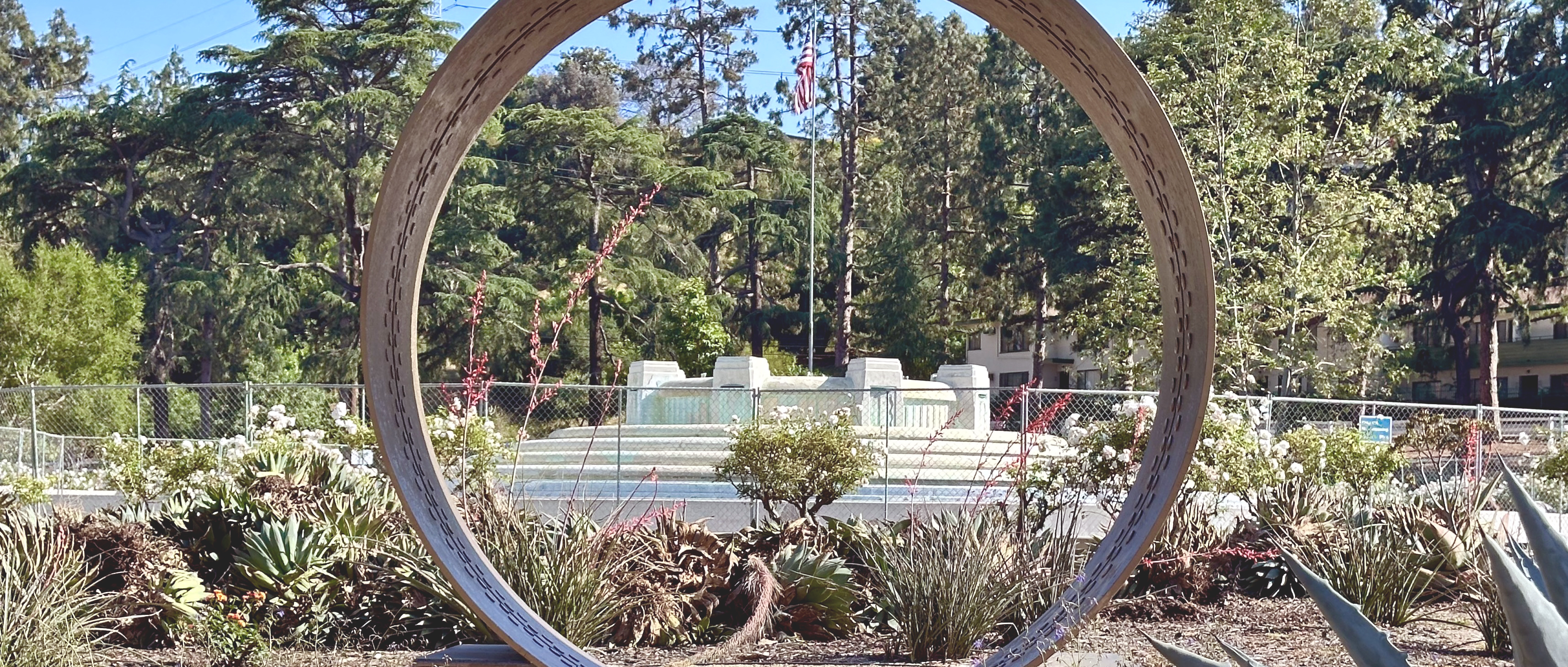 Mulholland fountain viewed through a decorative pipeline fragment.