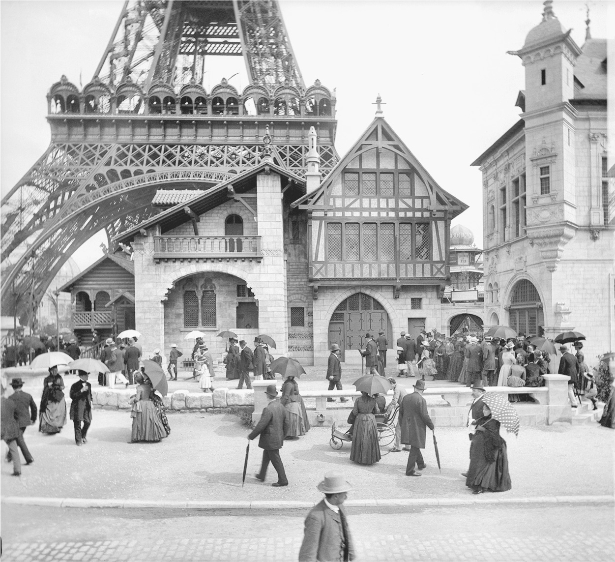 A photograph of people walking in front of the medieval house in the exhibition L’Histoire de l’Habitation Humaine.