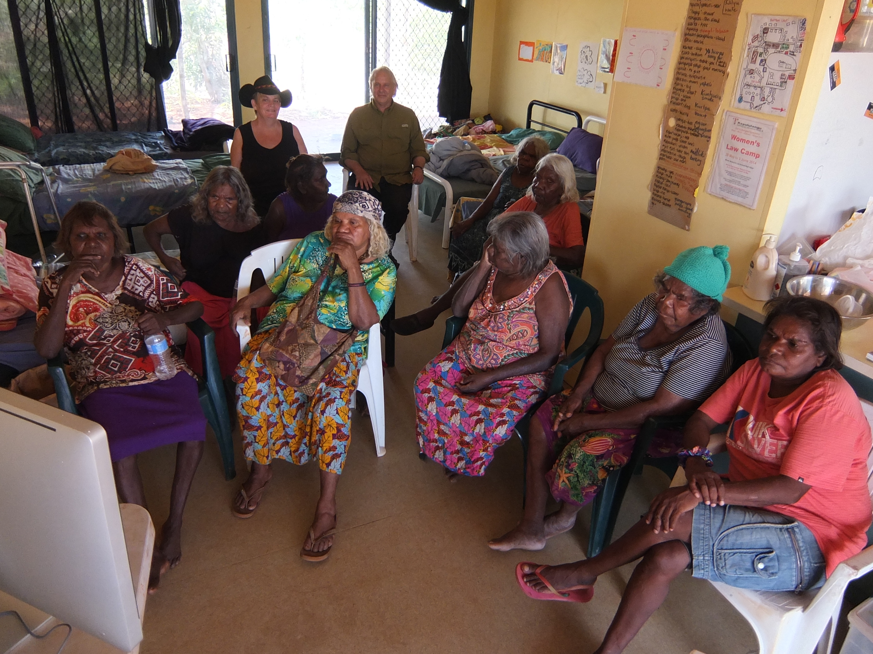 In a room at the women’s center with yellow walls and sliding doors, the Elders and others gather in plastic chairs around a computer showing the film
