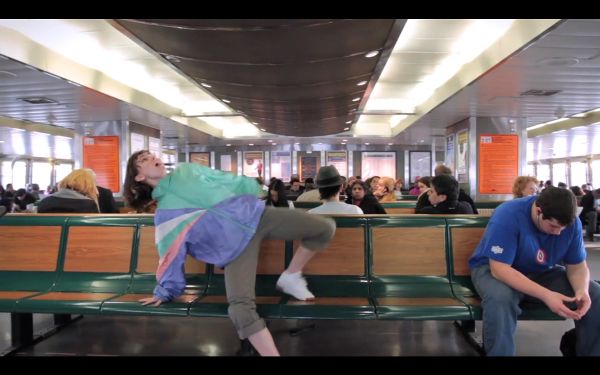 Young woman dancing on a public bench