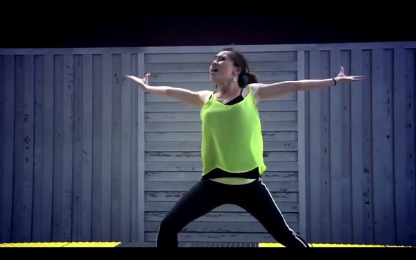 Young woman in active pose with both arms outstretched