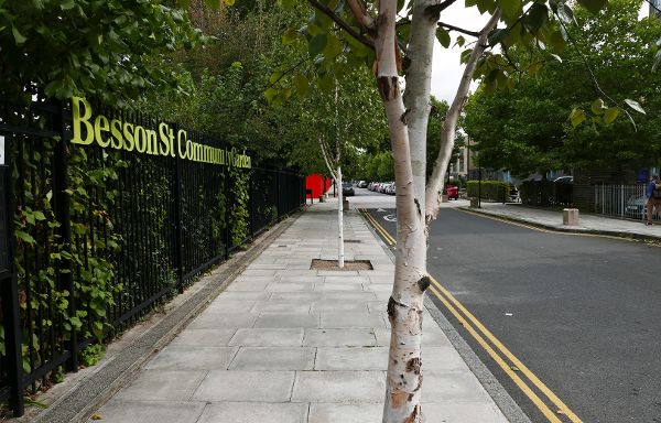 Besson Street Garden entrance and pedestrianized street with plantings in New Cross Gate, London.