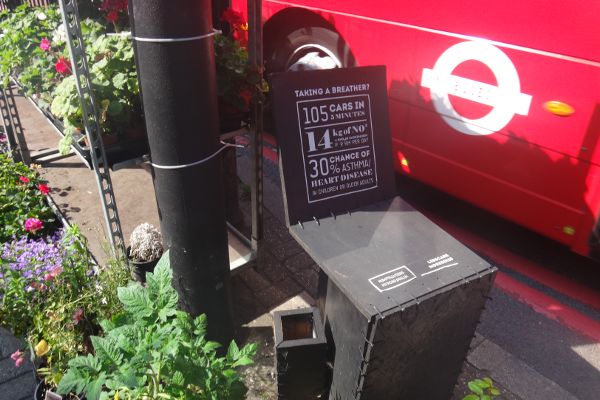 Sign providing facts about air pollution in London, including frequency of cars and increased chances of developing asthma.