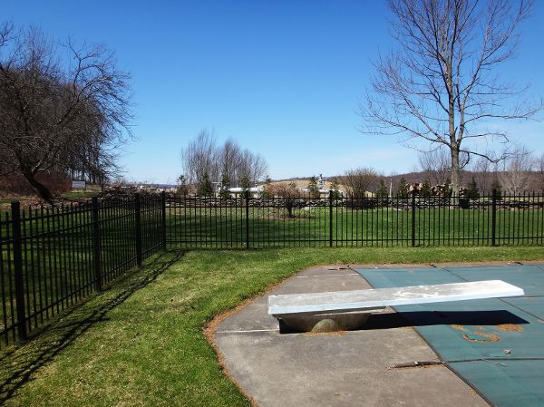 Residential swimming pool adjacent to fracking infrastructure and pipeline.
