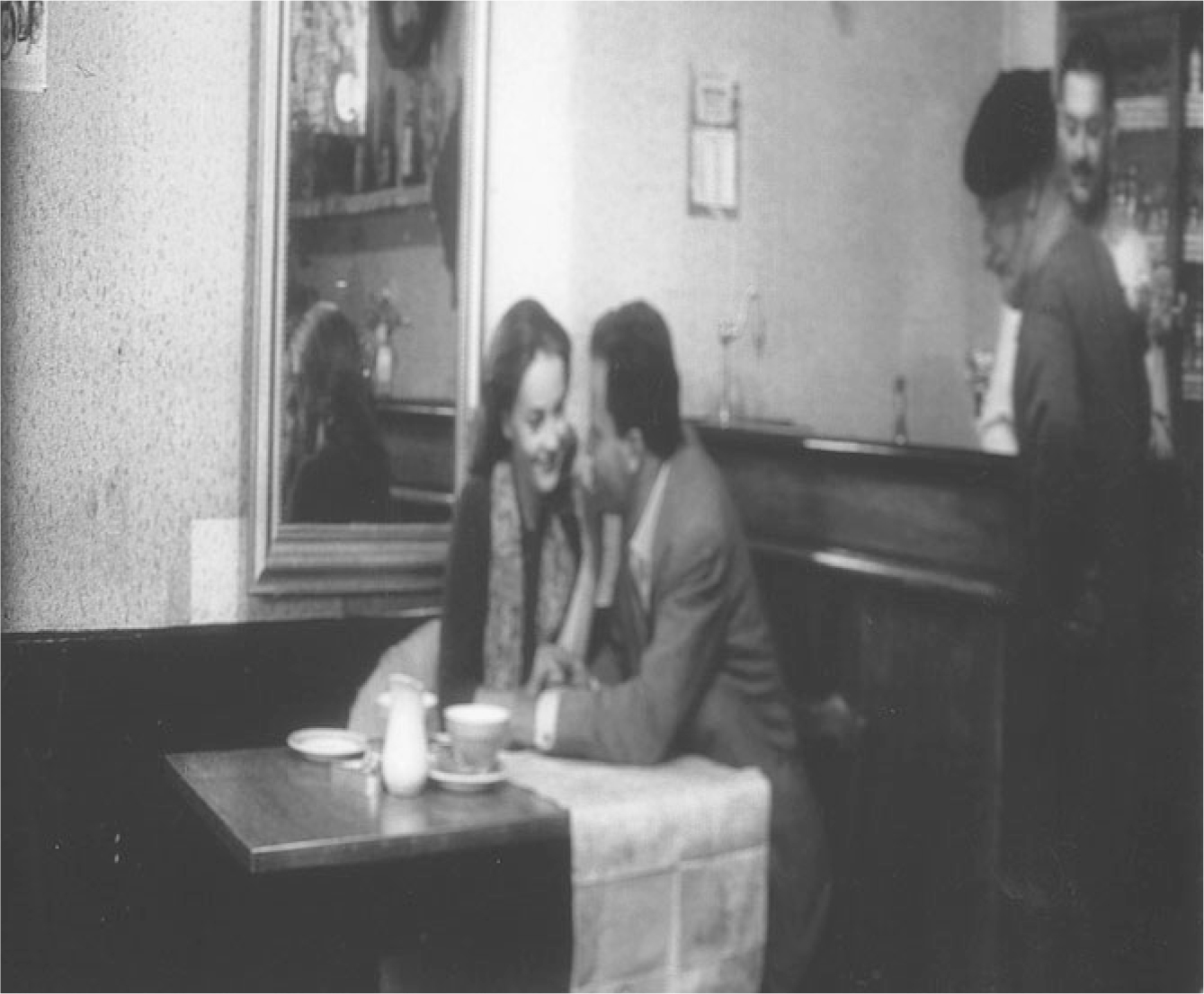 The exhibit showcases a scene from “Les Amants” where a couple is engaged in a conversation while seated in a restaurant.