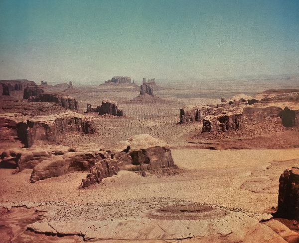 Elevated view of Monument Valley, with buttes and other rock formations.