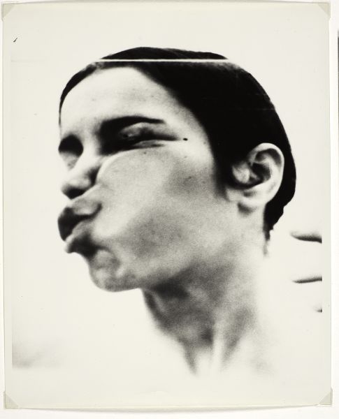 Side view of a woman's face pressed up against glass