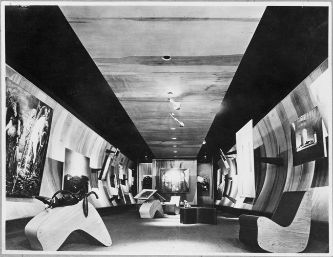 The exhibit displays Frederick Kiesler’s Surrealist Gallery (looking south) at the Art of This Century gallery in New York.