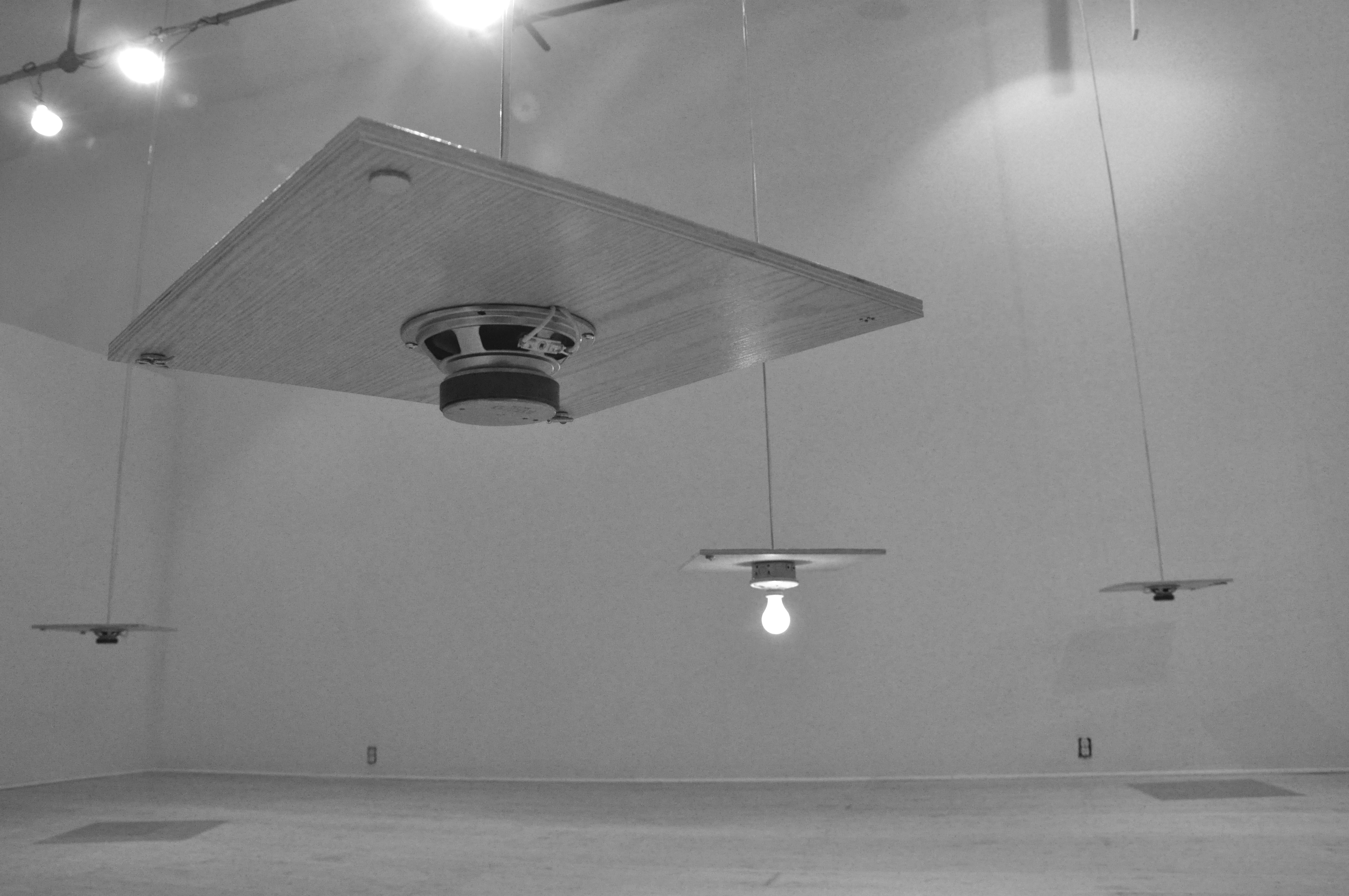 Installation detail of Basement Suite photographed from ground level so as to show the underside of the suspended wooden panels.