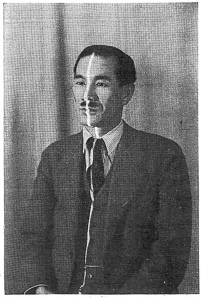A thin white line of light is visible capturing the contours of the upper half of man with a mustache, dressed in a suit, and seated.