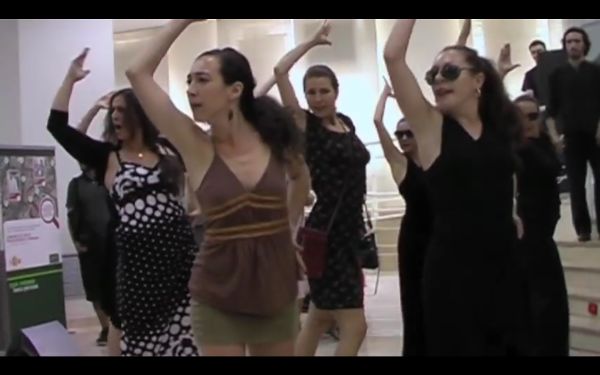 Nine dancers performing the flamenco in a bank