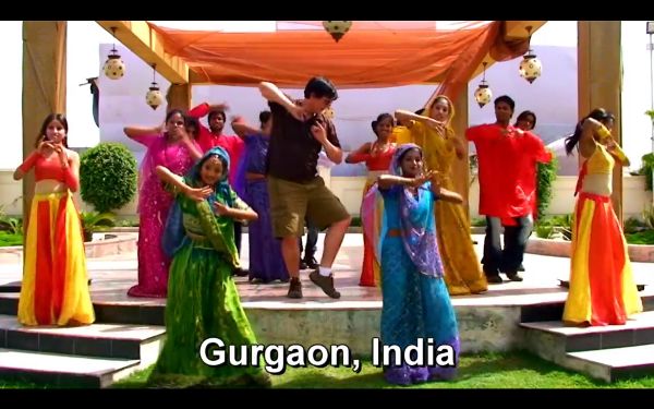 A small troupe of dancers performing in traditional Indian garb