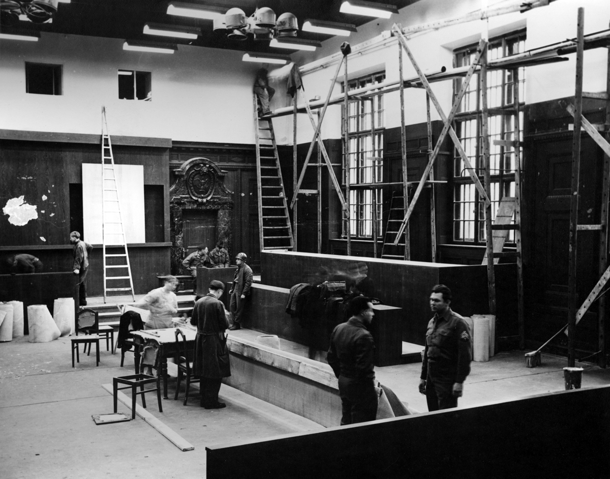 Photograph of Courtroom 600 under construction with working crews, scaffoldings, and ladders against walls.