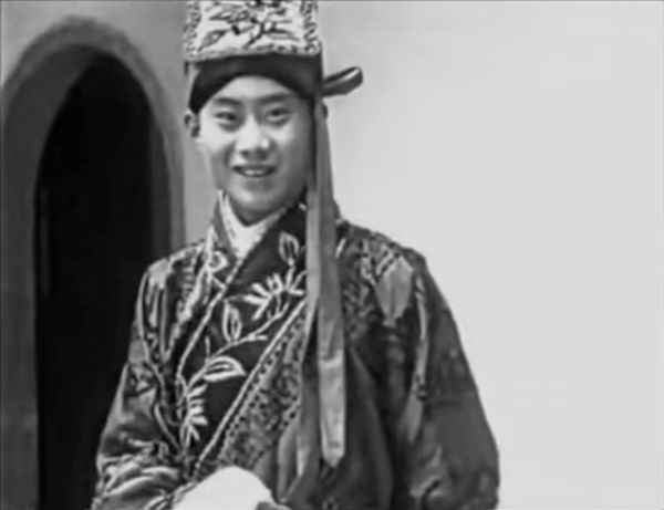 Monk in traditional garb facing the camera.