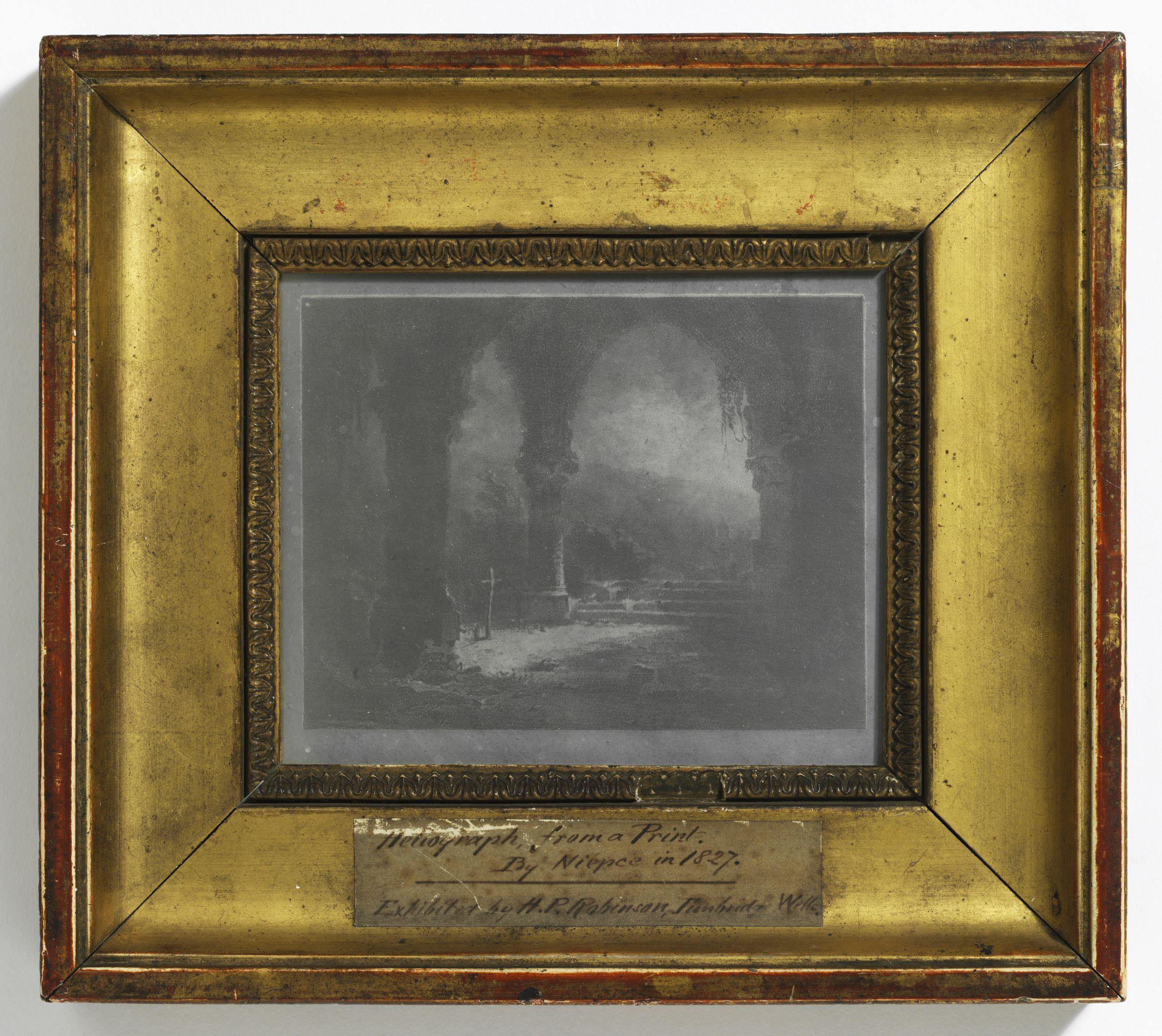 Photograph of a photographic contact print of an engraving showing the ivy-covered vaulted arches of an old abbey under moonlight.