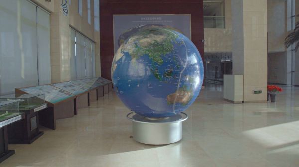 A photographic image of a model globe inside a public building.