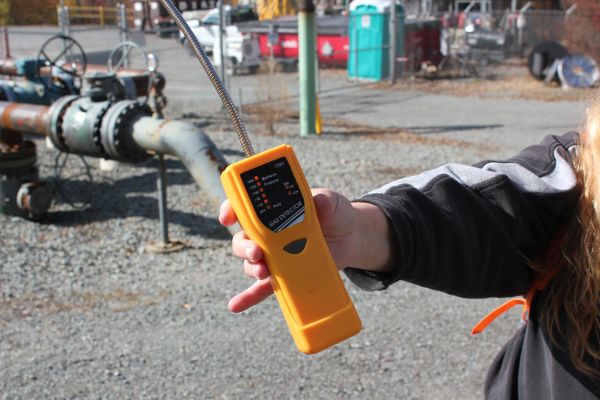 Citizen demonstrating the use of a natural gas methane monitor in proximity to fracking infrastructure in Pennsylvania.