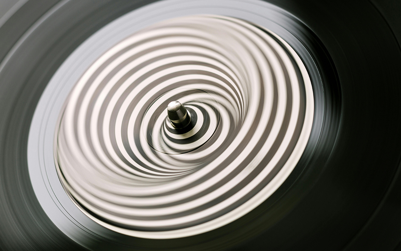 Vinyl record spinning creating a striped optical illusion at center.