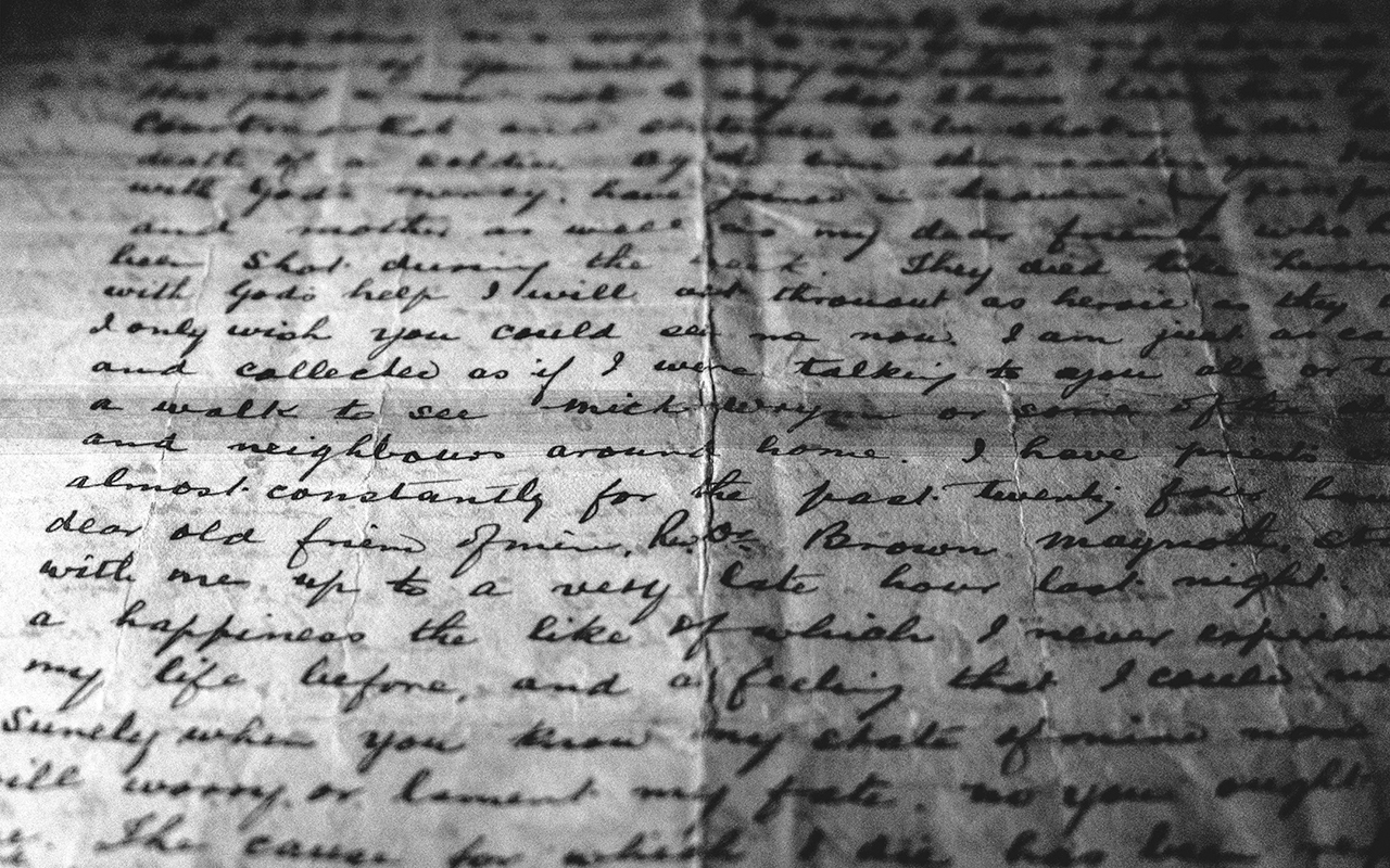 Wrinkled leaf of paper covered entirely by cursive handwritting.