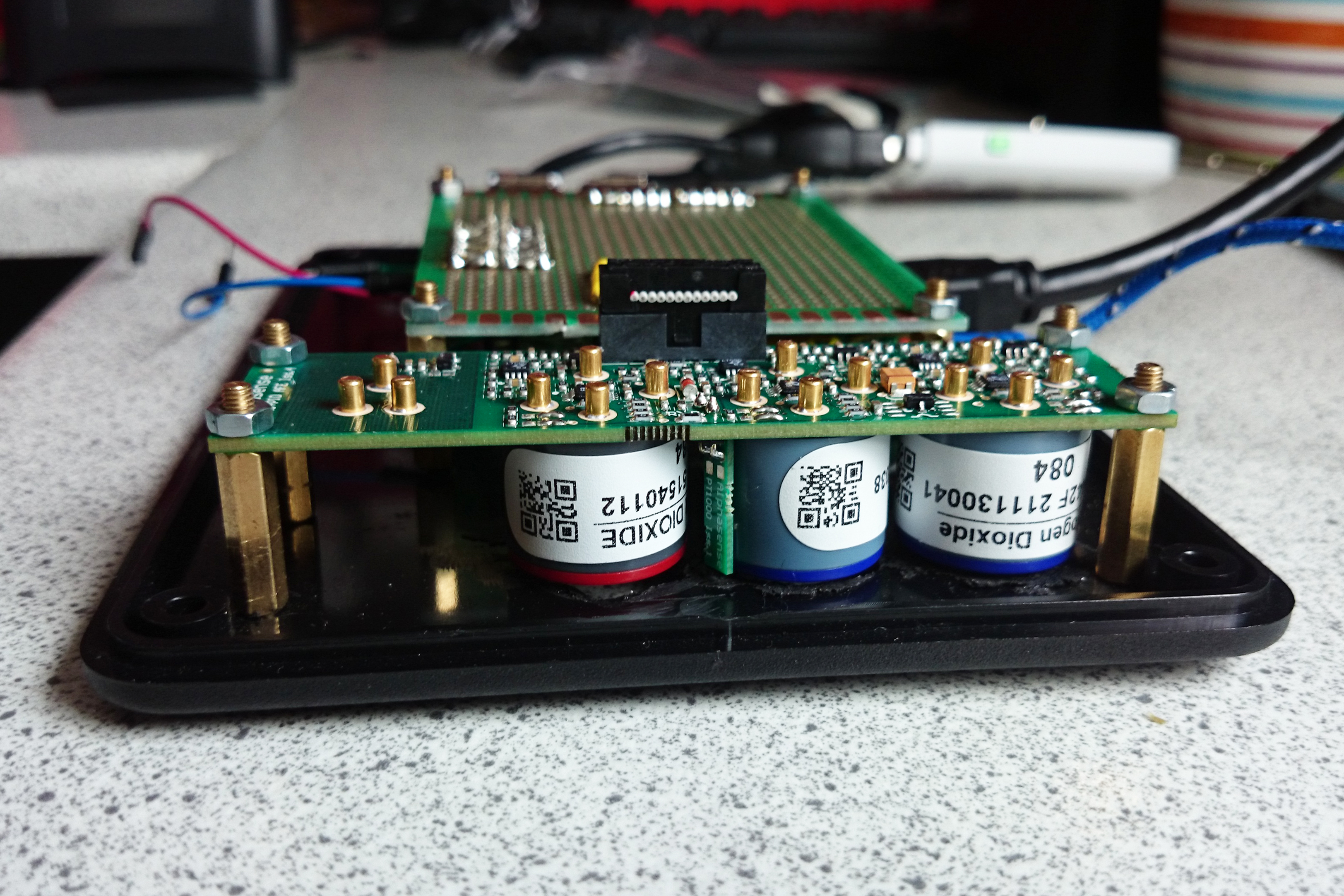 Sensors resembling diodes attached to a circuit board mounted to a pice of black casing.