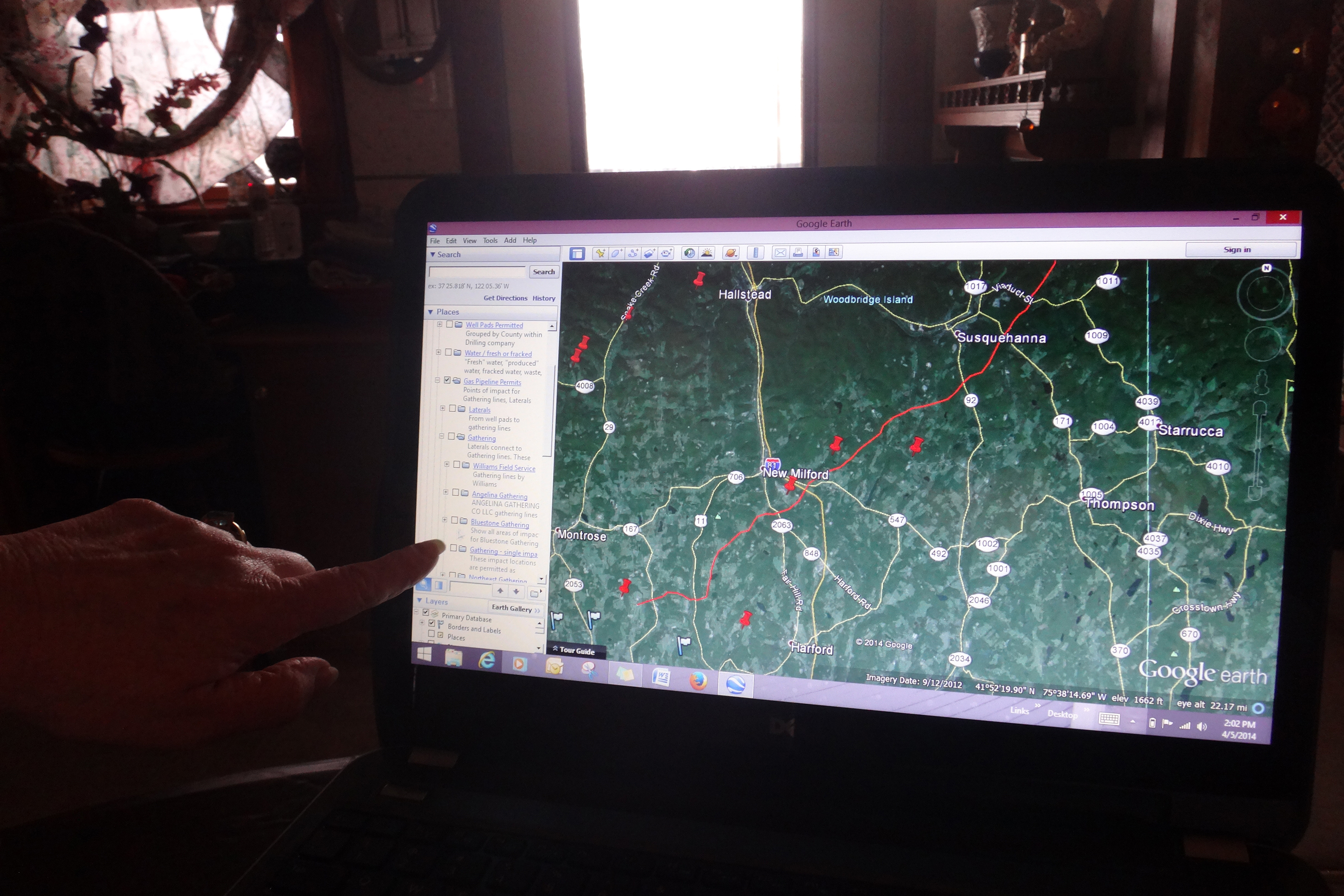 A laptop screen showing Google Earth open to a view showing Susquehanna and New Milford with red pushpin icons placed in various spots.